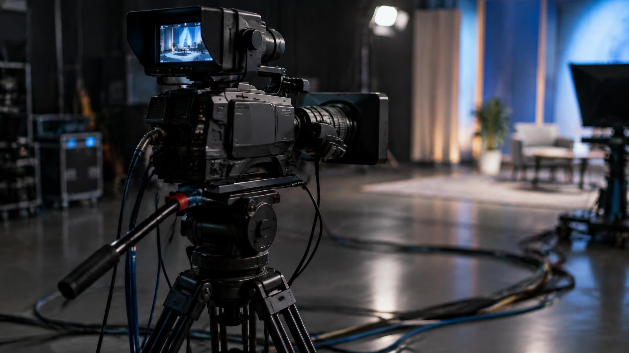 Professional broadcast camera on a tripod in a studio